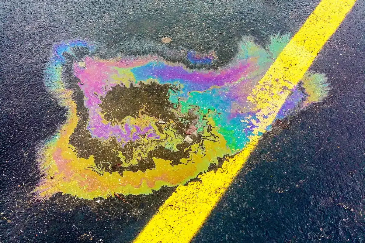 Gasoline leak on wet pavement. Photo courtesy of Pexels: https://www.pexels.com/photo/black-road-close-up-photography-2570700/