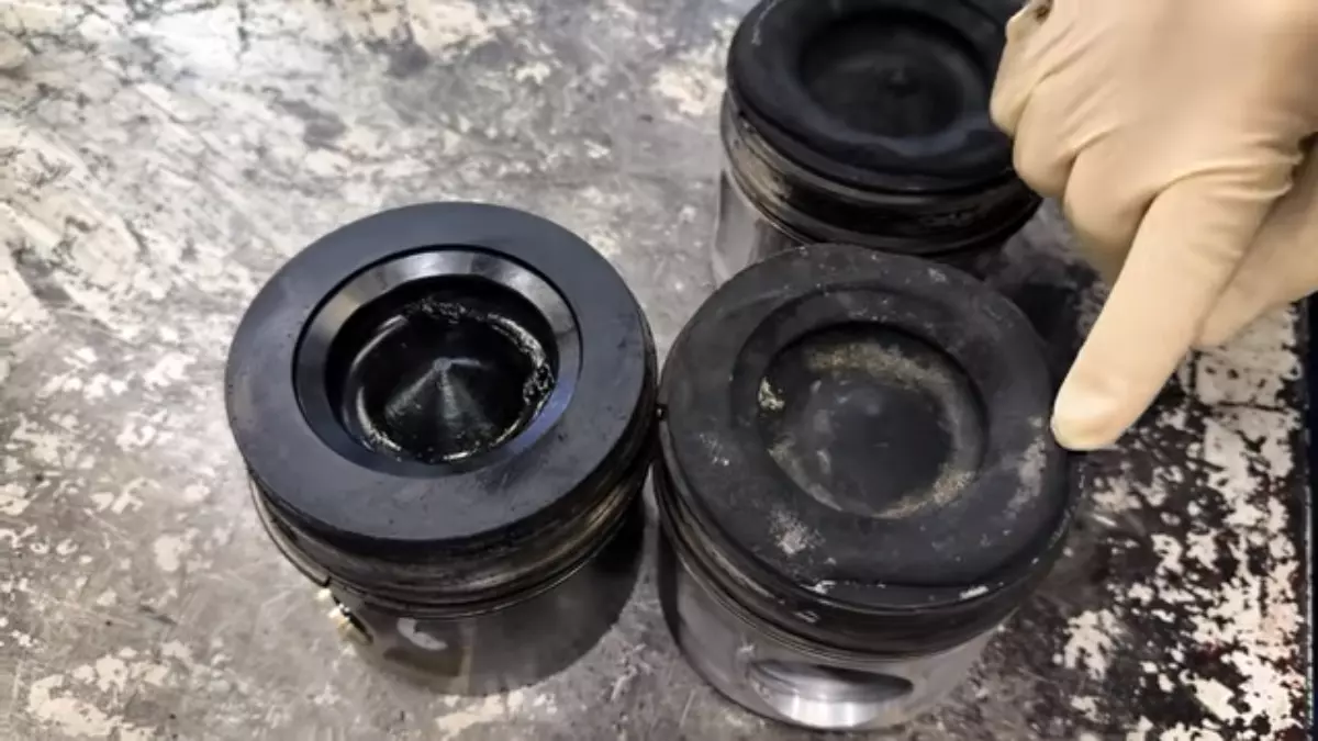 Overheated piston versus a clean one. Screen capture from Daves Auto Center / YouTube