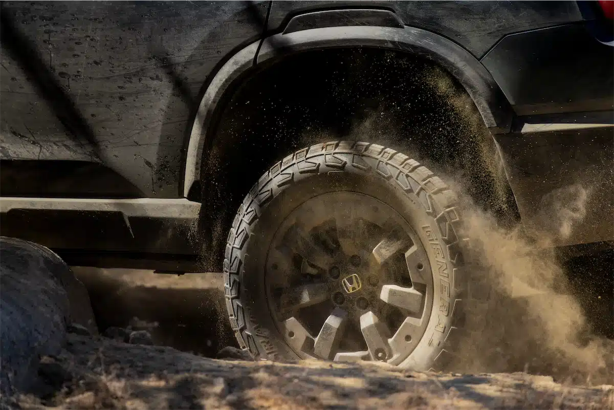 Close-up of the 2027 Passport TrailSport's all-terrain tire and off-road wheel