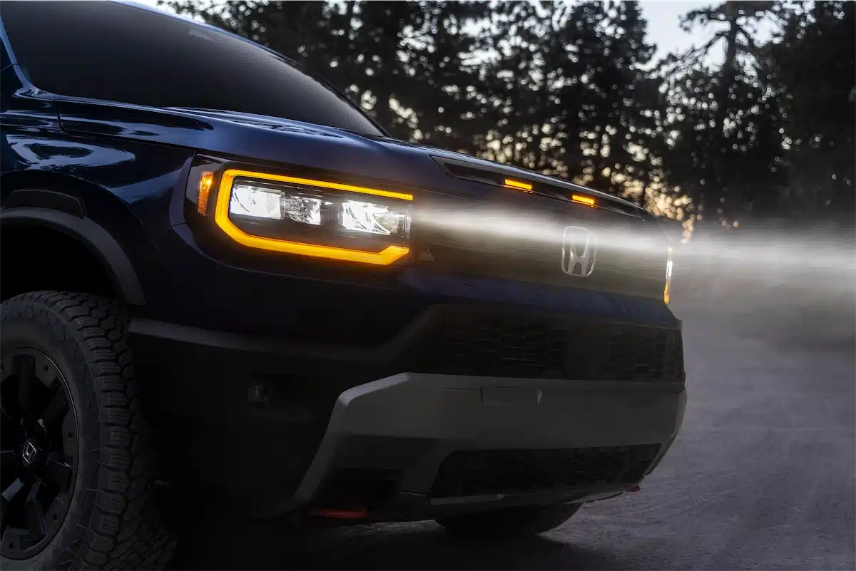 Close-up of the 2027 Passport TrailSport's amber LED headlight and grille