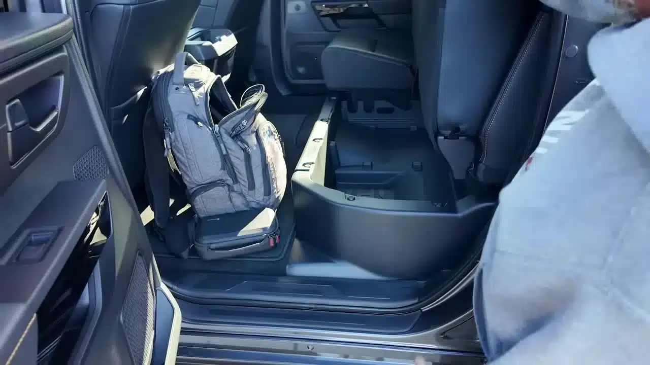Rear seat raised to show under-seat storage in the nonhybrid Tundra CrewMax