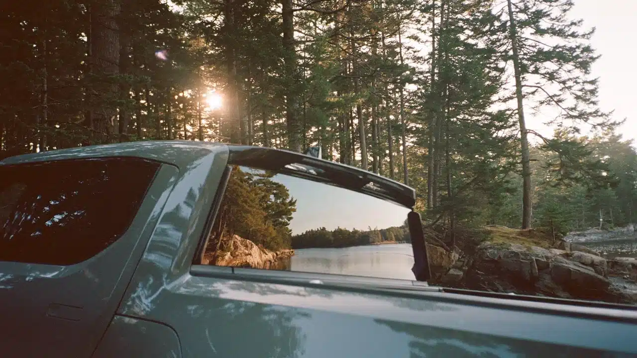 Rivian R1T pickup bed and rear cab window in a forest