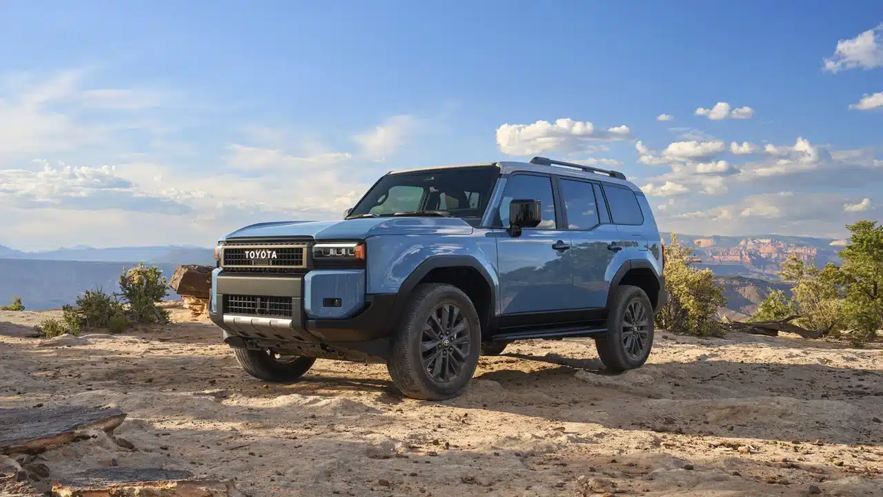 Blue 2027 Toyota Land Cruiser parked on a rocky overlook