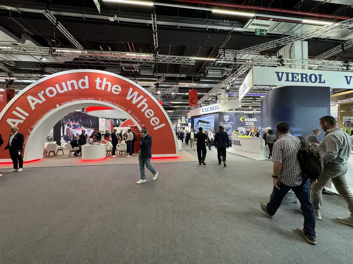 Visitors walk among parts suppliers on the exhibition floor.