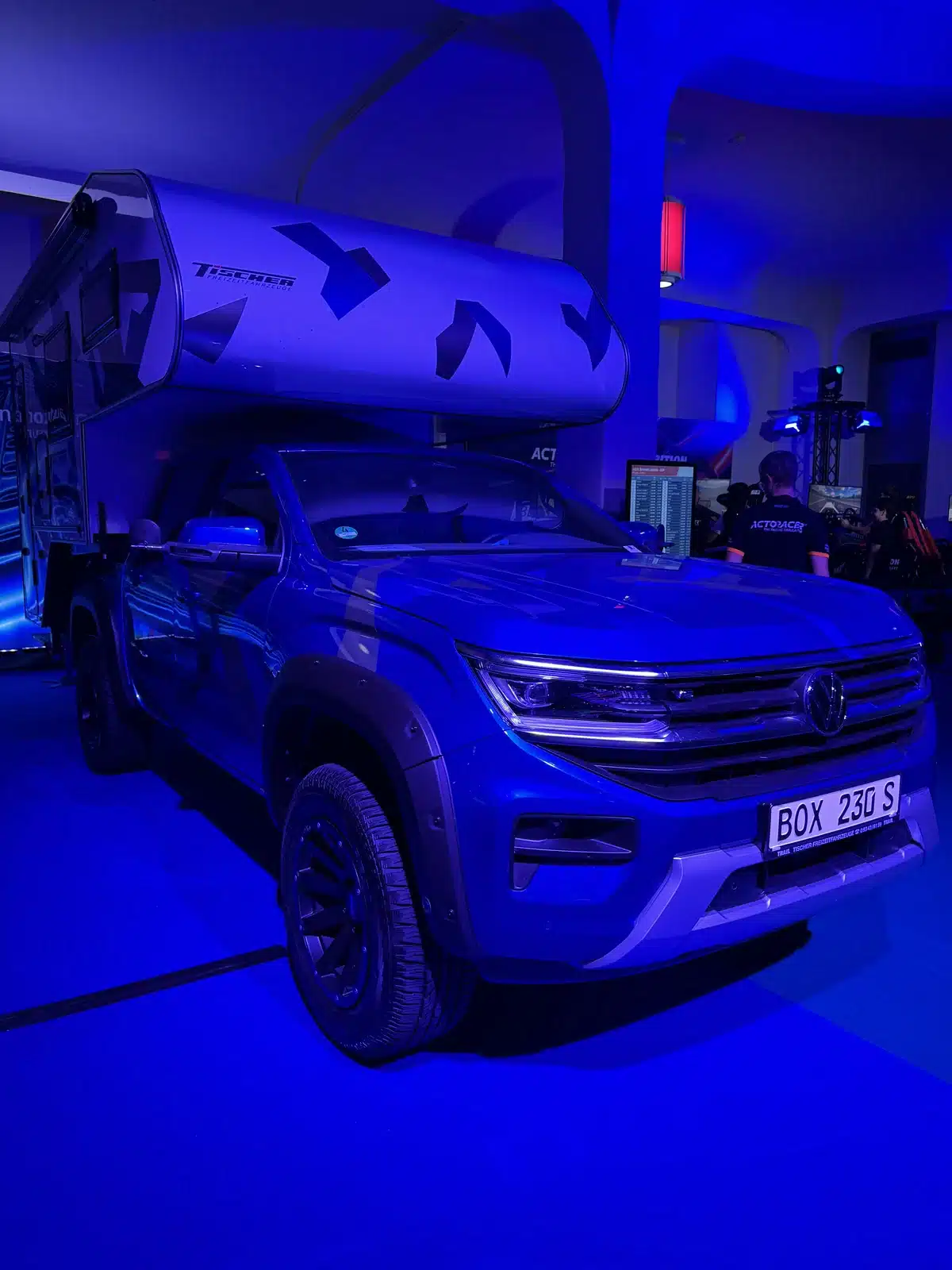 A Volkswagen pickup carries a Tischer camper.
