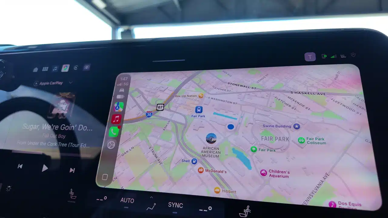 Apple CarPlay map beside GM audio controls in the display truck