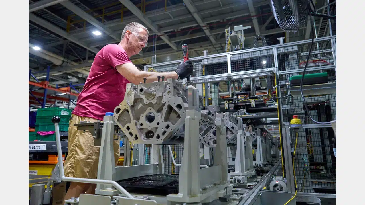 A GM employee assembling an engine at the Flint plant