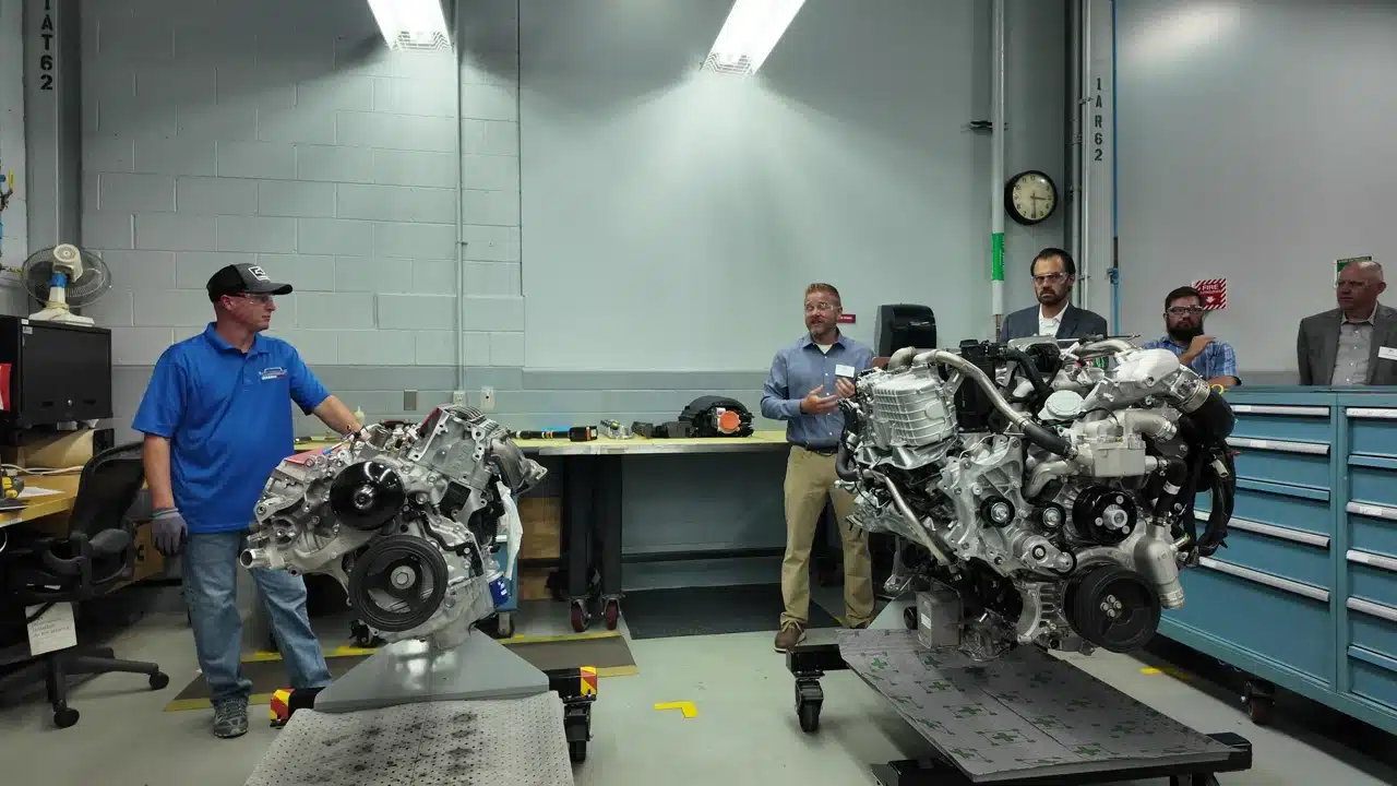 Mike discussing engine development and testing beside engines