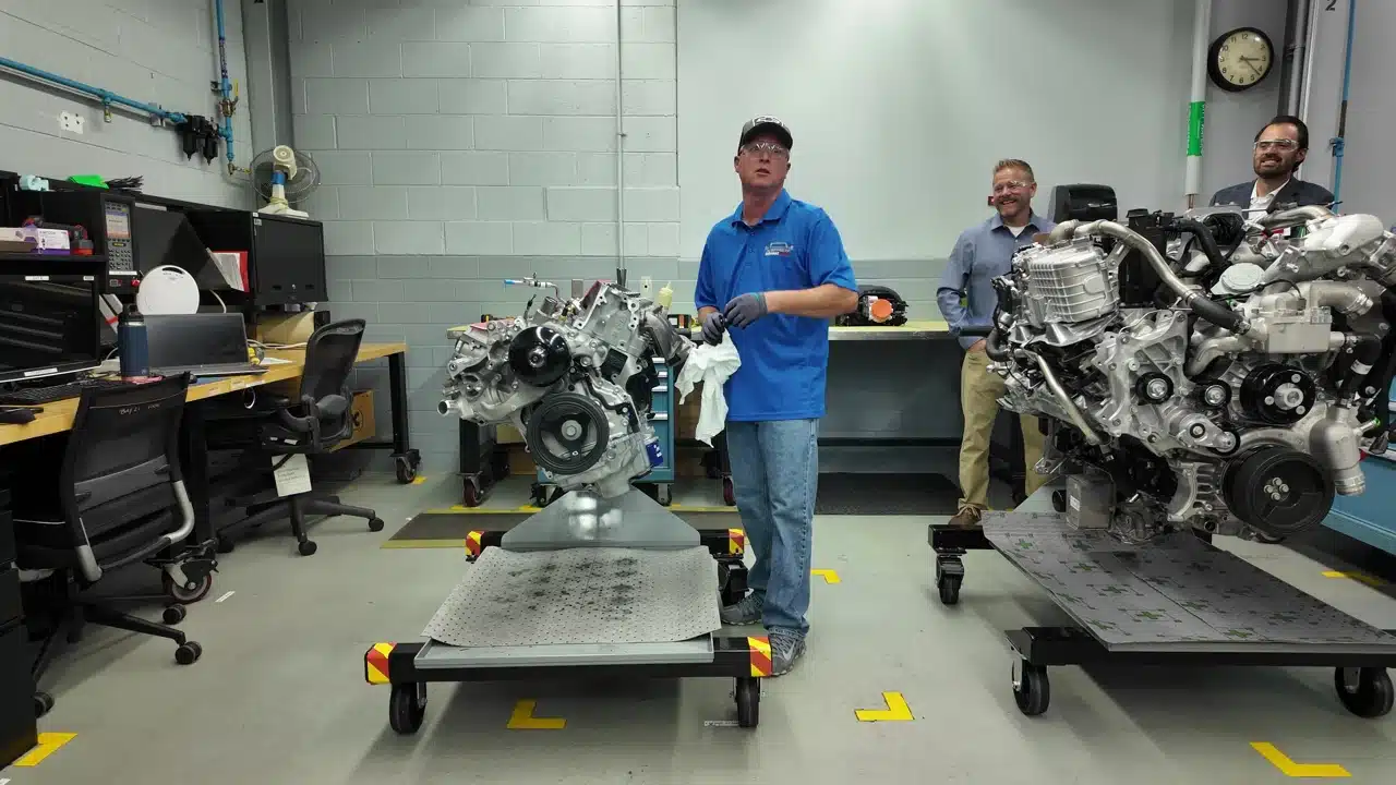 GM technician beside an engine in the development build room