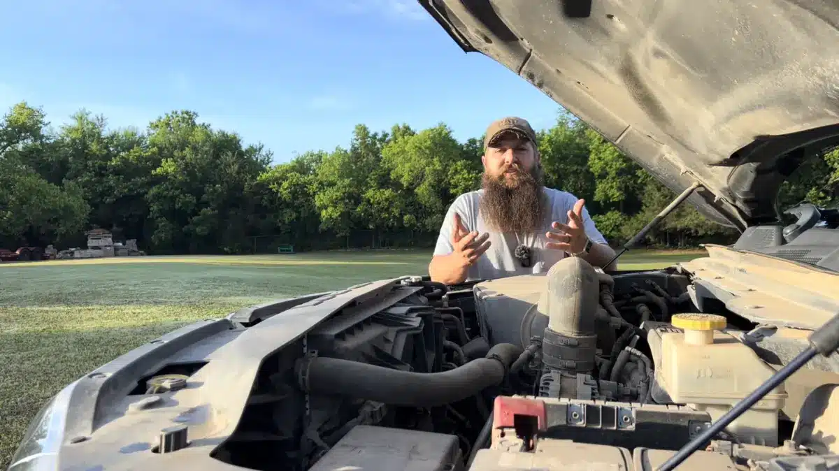Ram 1500 owner standing behind the open hood before repairing the Hemi engine
