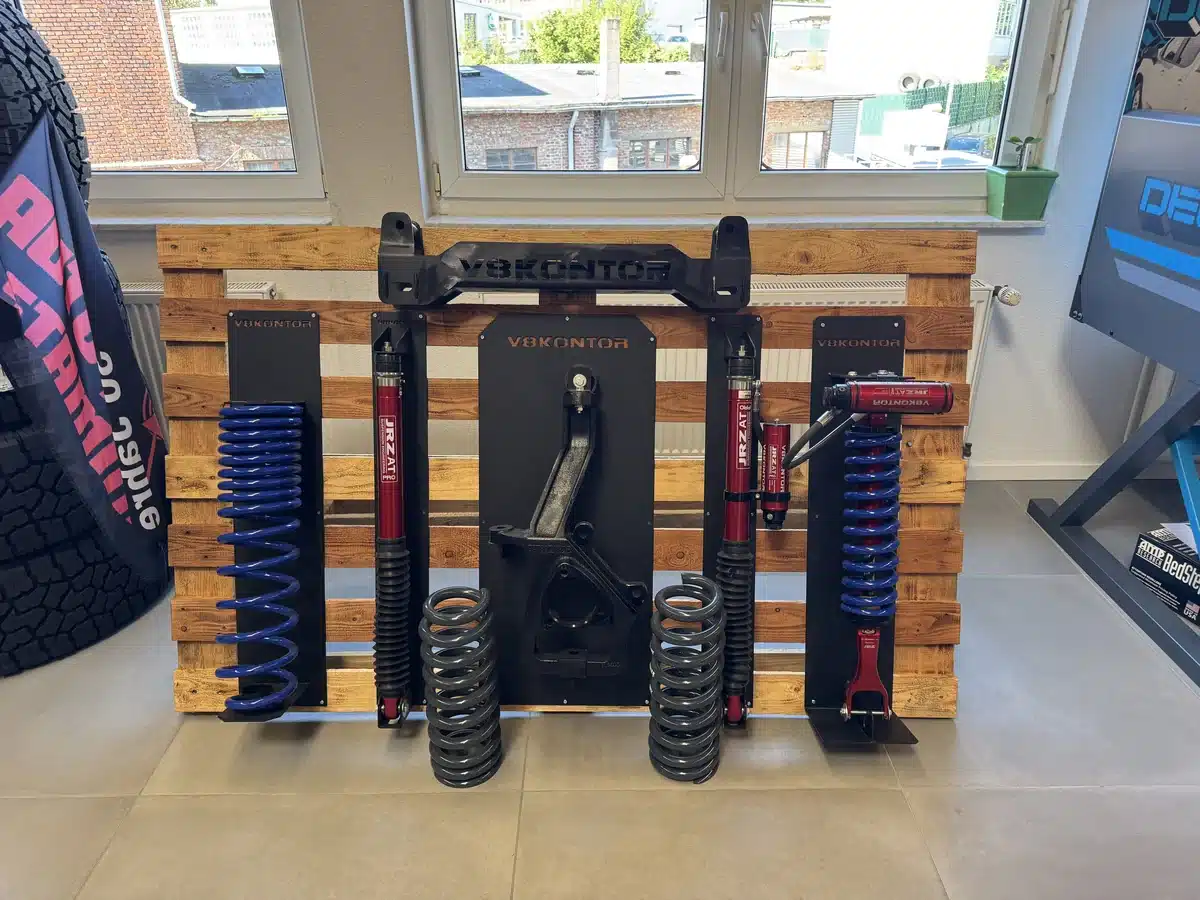 Suspension components displayed beside the showroom window.