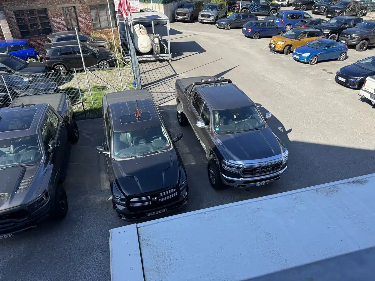 Trucks and vehicles parked below the showroom window.