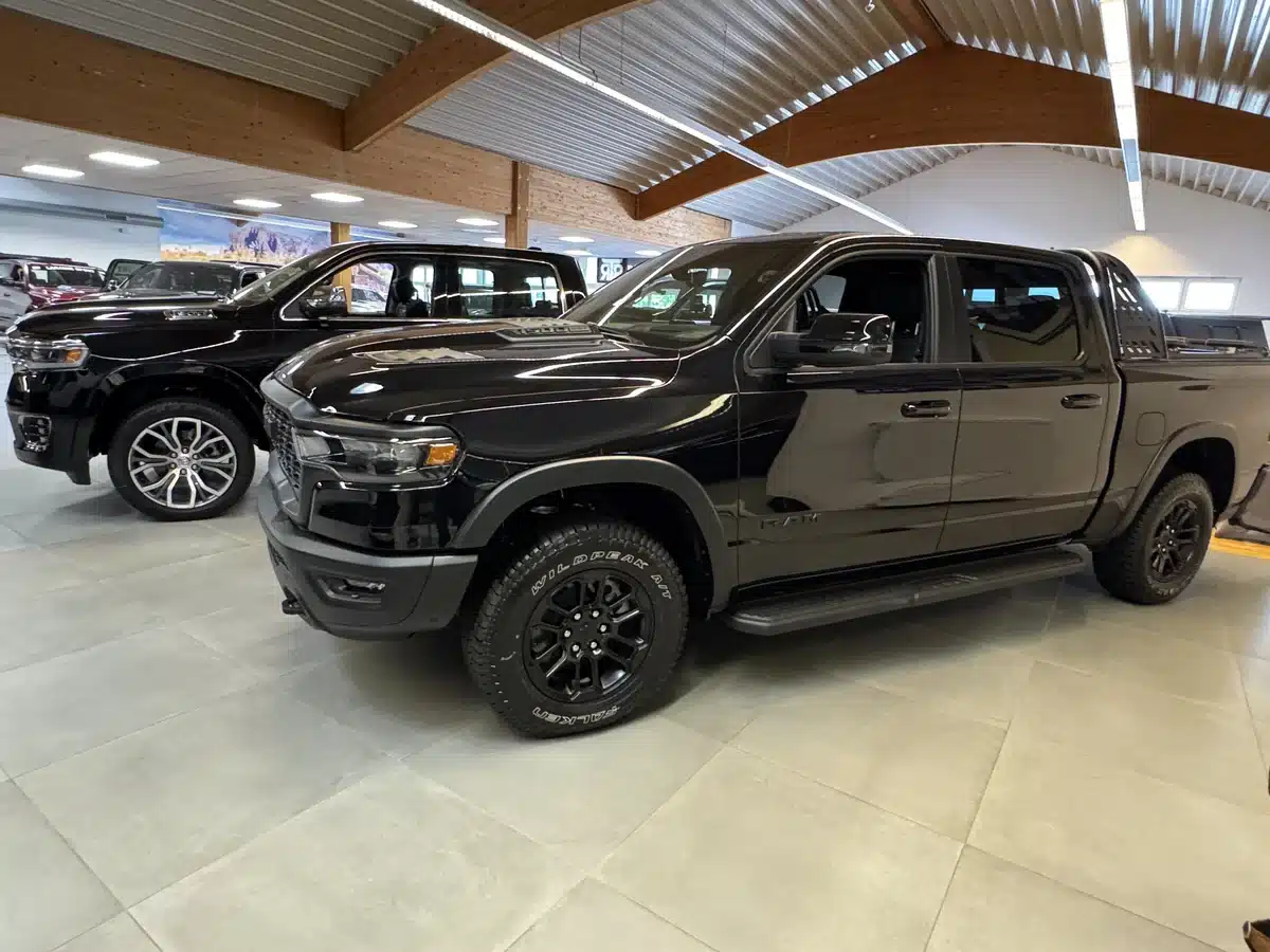 Rows of Ram pickups inside the RTR Ram Truck Ranch showroom.