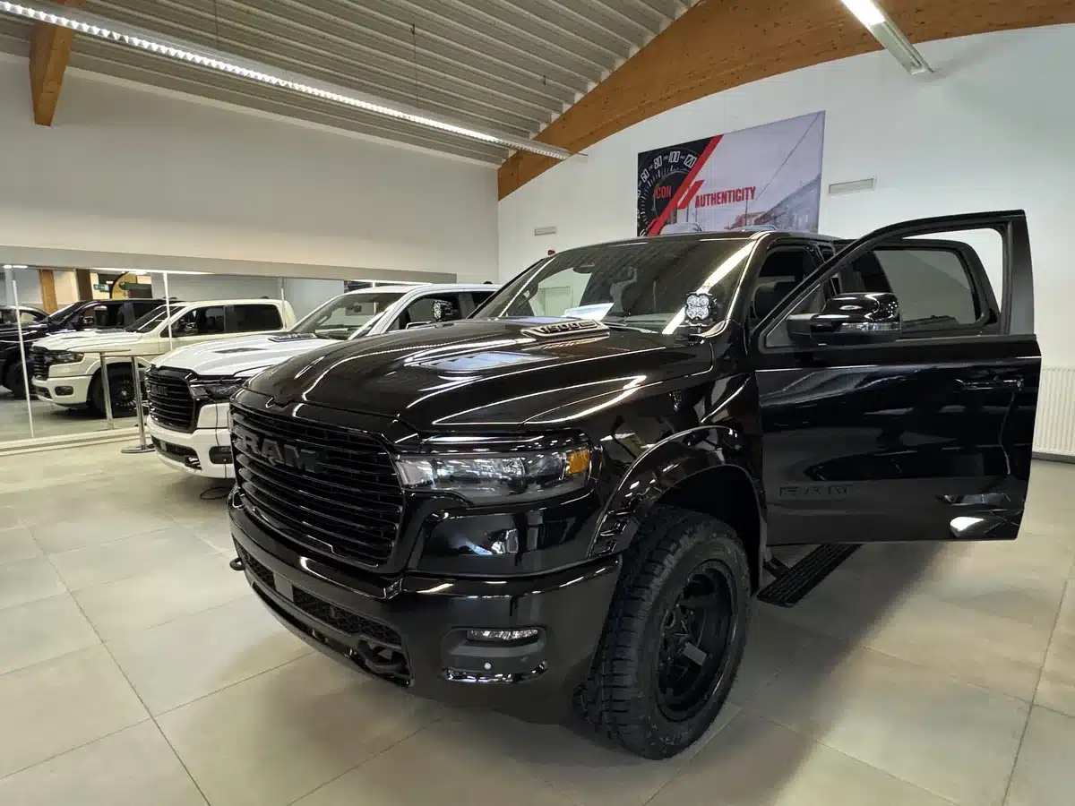 Front three-quarter view of a black Ram with its driver door open.