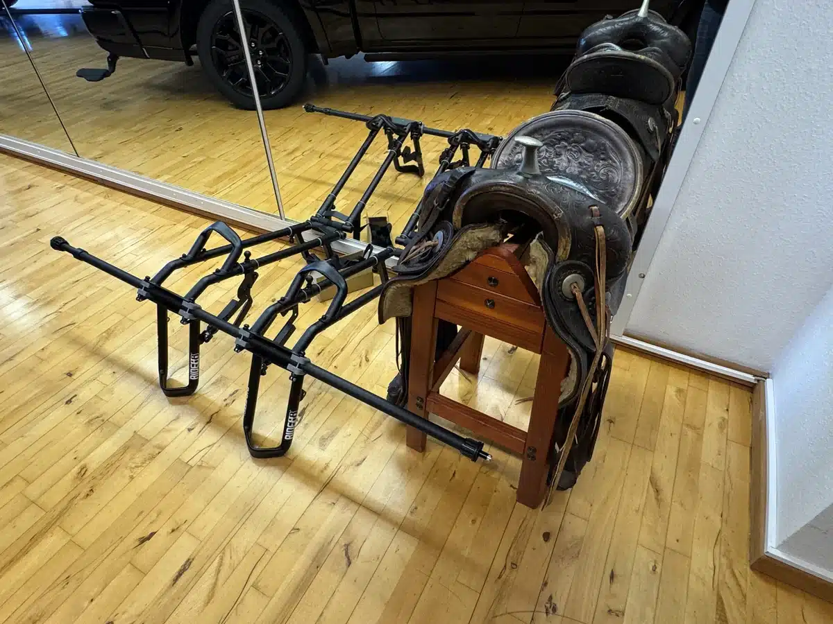 Saddle and equipment displayed beside the trucks.