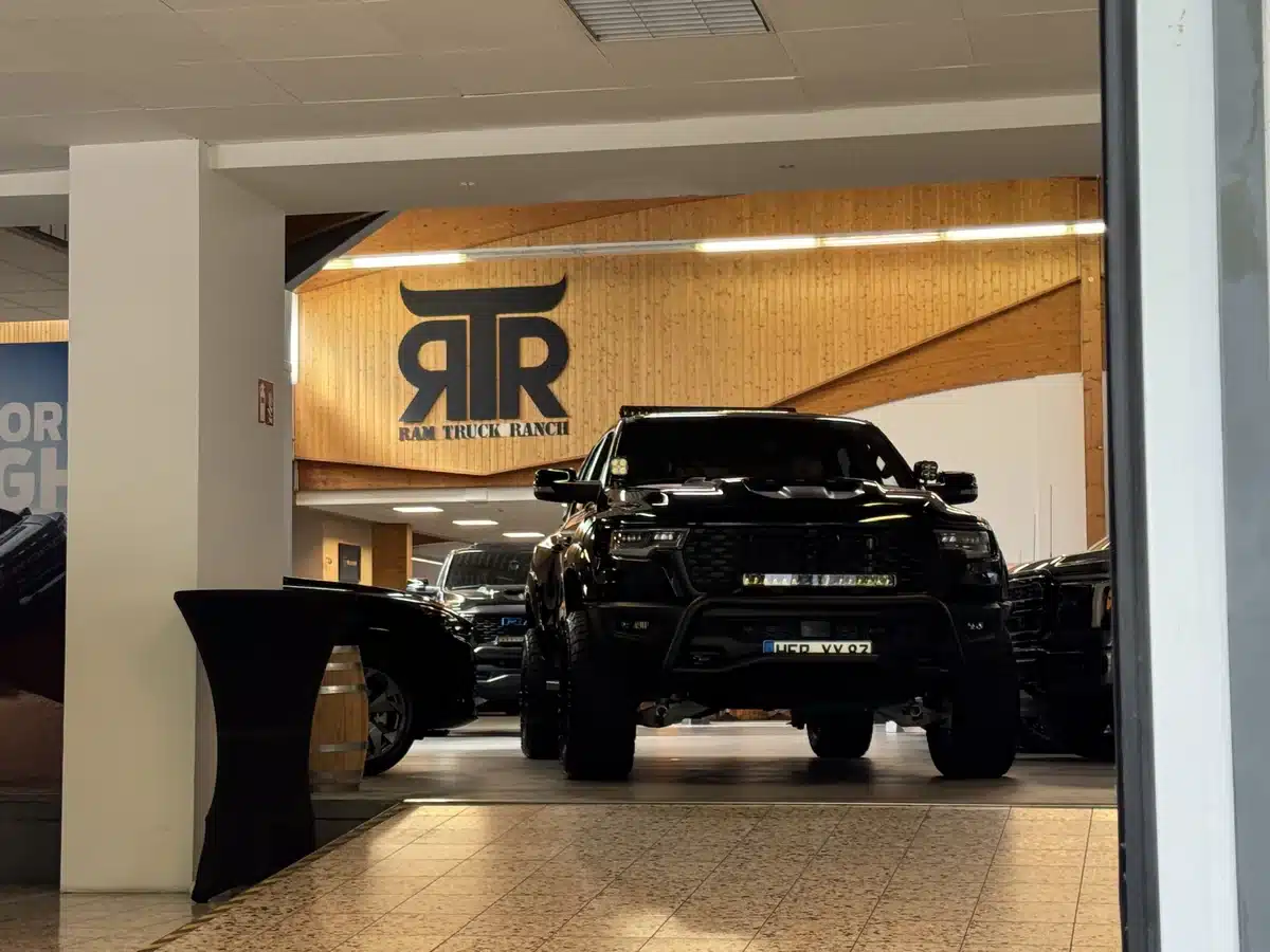 Ram pickup beneath the RTR wall logo, seen through a doorway.