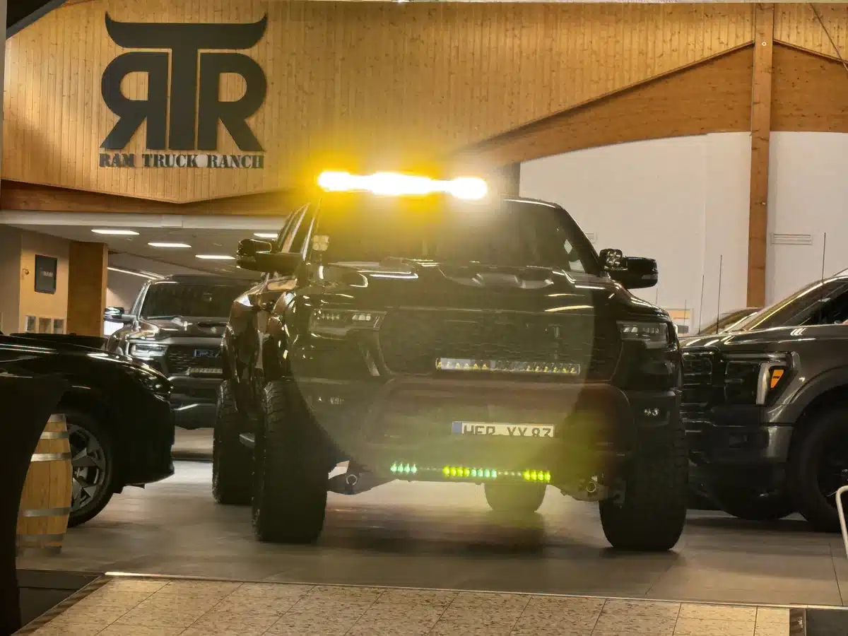 Customized Ram pickup with amber roof lights illuminated.