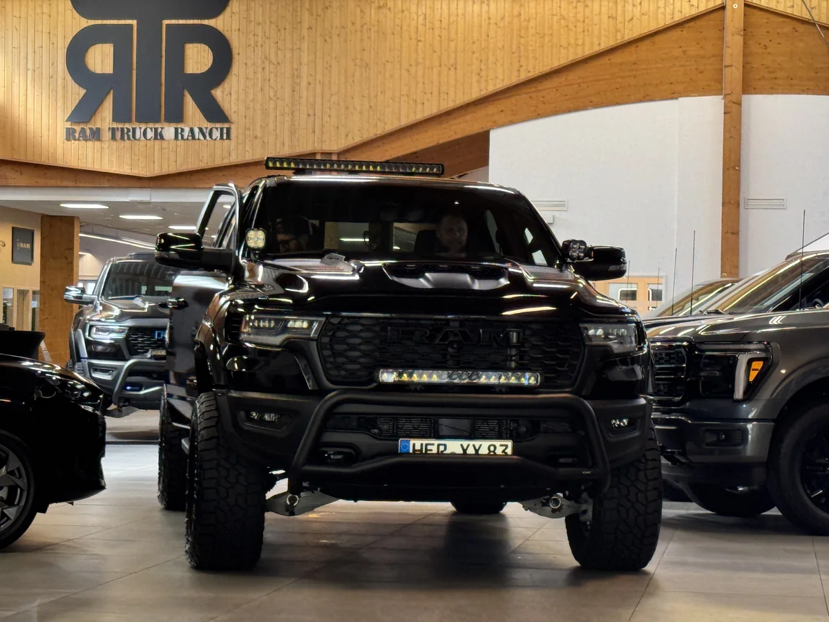 Black lifted Ram pickup beneath the RTR Ram Truck Ranch logo.