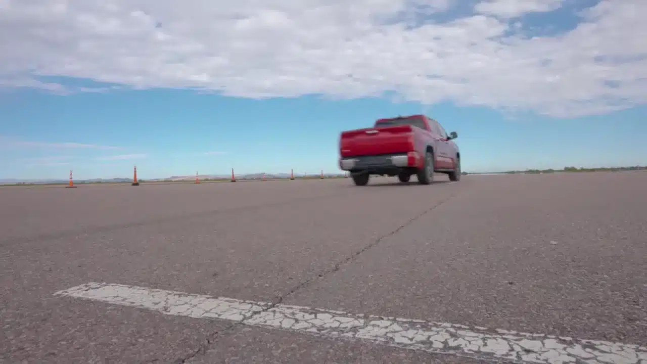 Toyota pickup driving on a paved proving-ground test surface