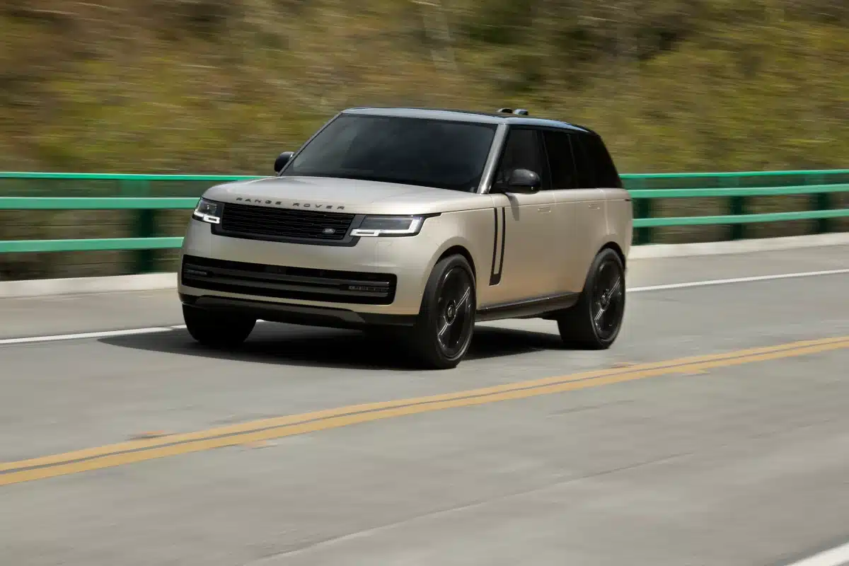 A pale gold-colored Land Rover Range Rover on the road.