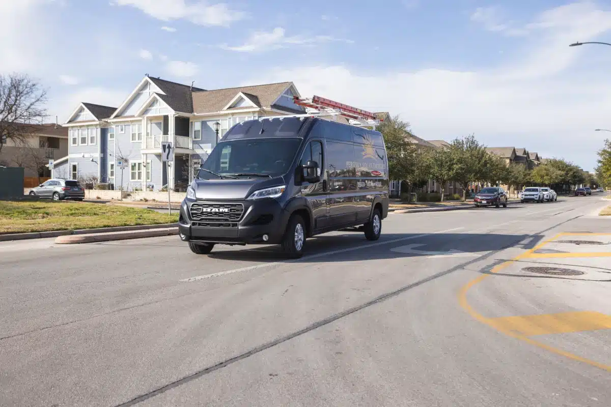A 2025 Ram ProMaster work van on a residential street.