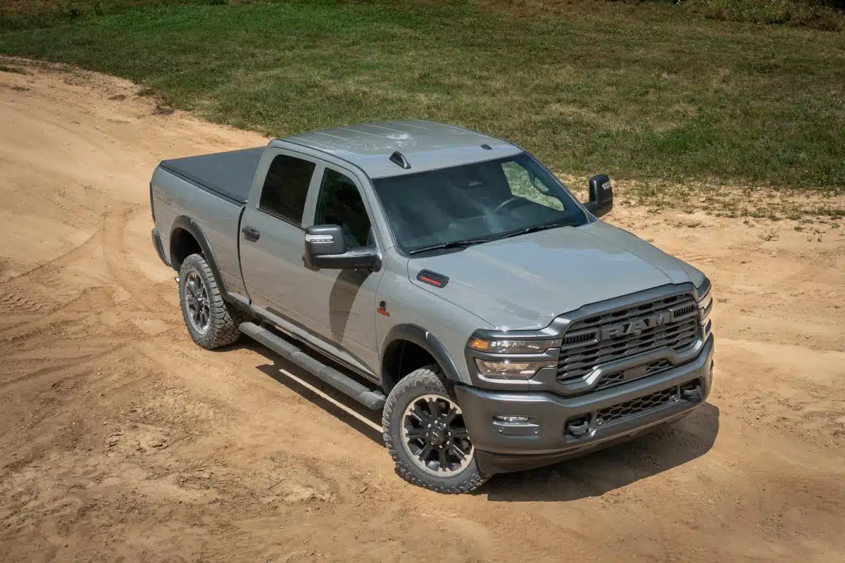 A gray Ram 2500 pickup truck on a dirt road.