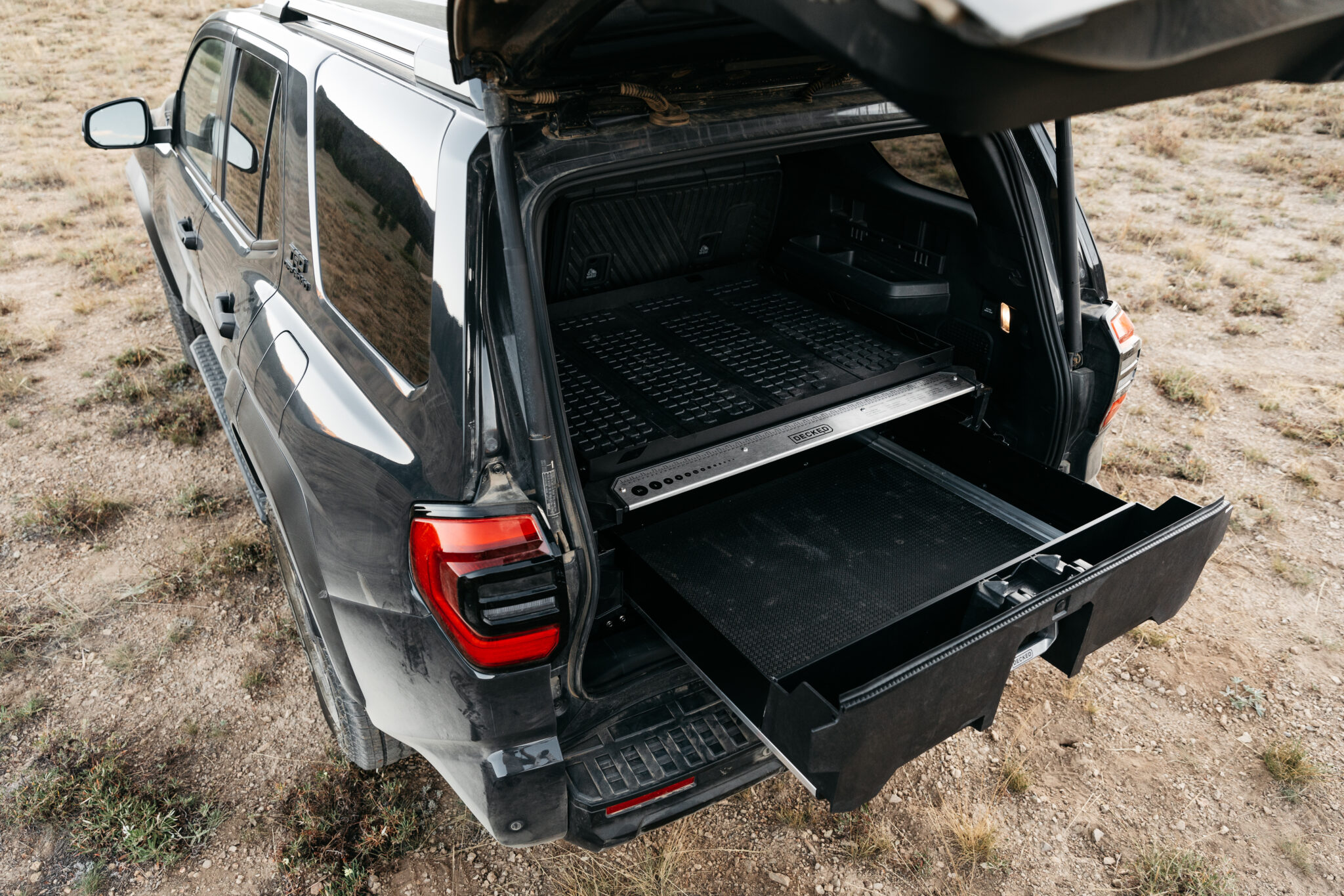 Open DECKED drawer and upper cargo tray in a Toyota 4Runner.