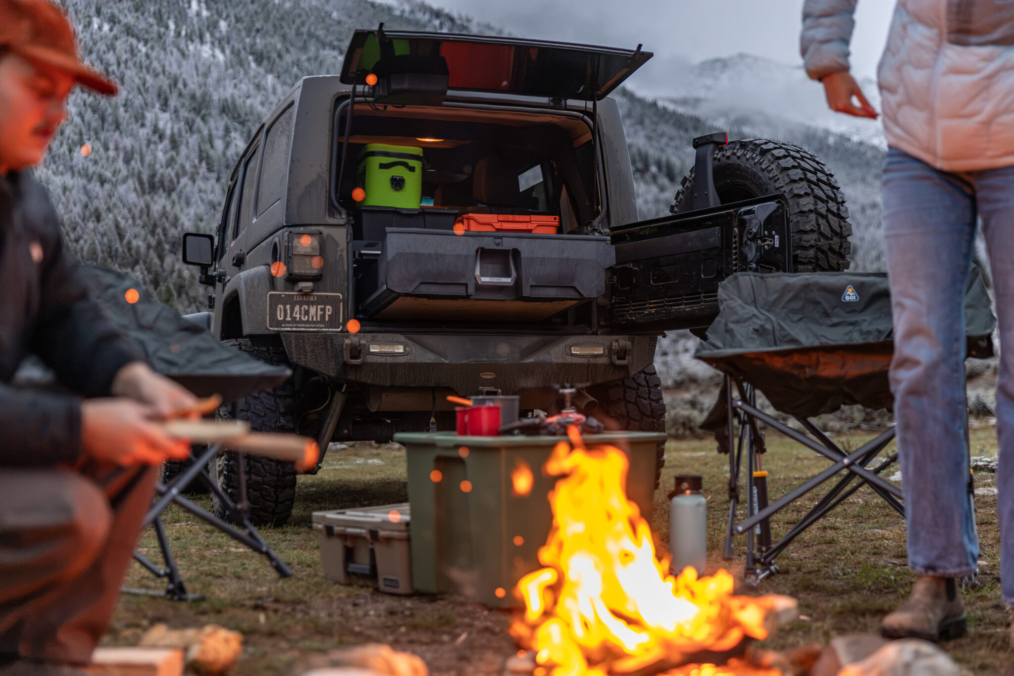 DECKED SUV drawer system extended from a Jeep Wrangler at a campsite.