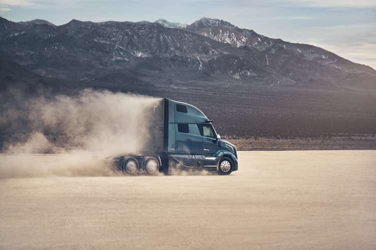Volvo VNL diesel semi truck driving across a flat landscape