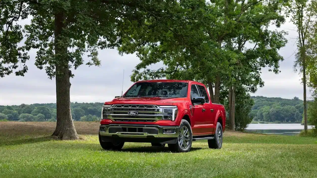 Red 2027 Ford F-150 Lariat parked beside a lake