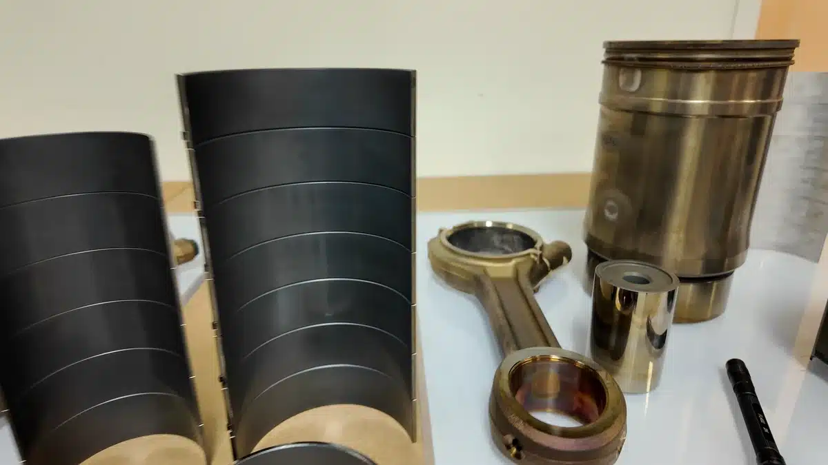 Cutaway cylinder liners, a piston and a connecting rod from Shell’s engine-component display.