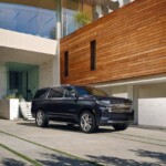 The 2023 Suburban High Country front three-quarter view parked. (Image courtesy of General Motors)